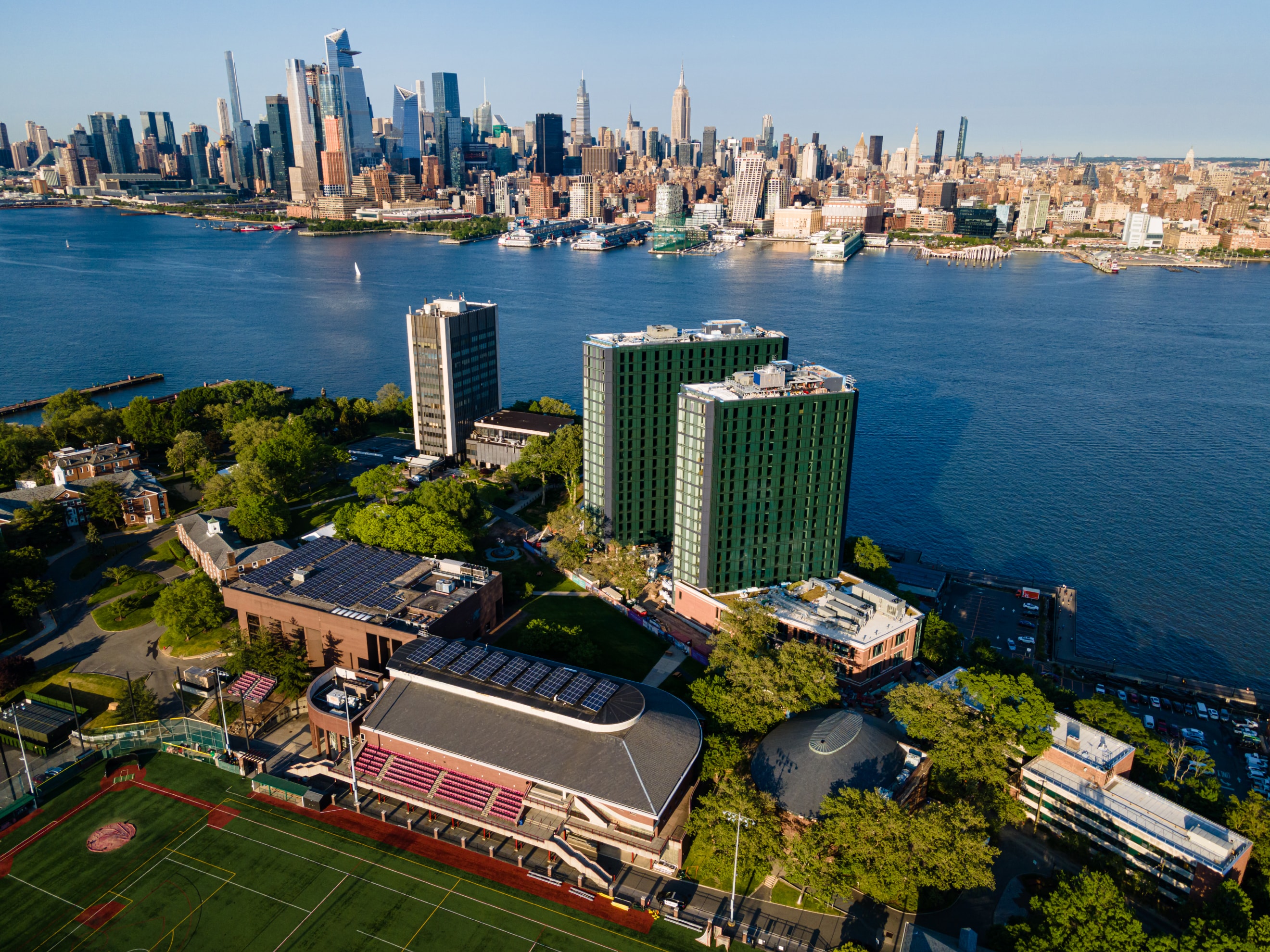 Aerial of the Hoboken campus with the Midtown Manhattan skyline directly across the Hudson