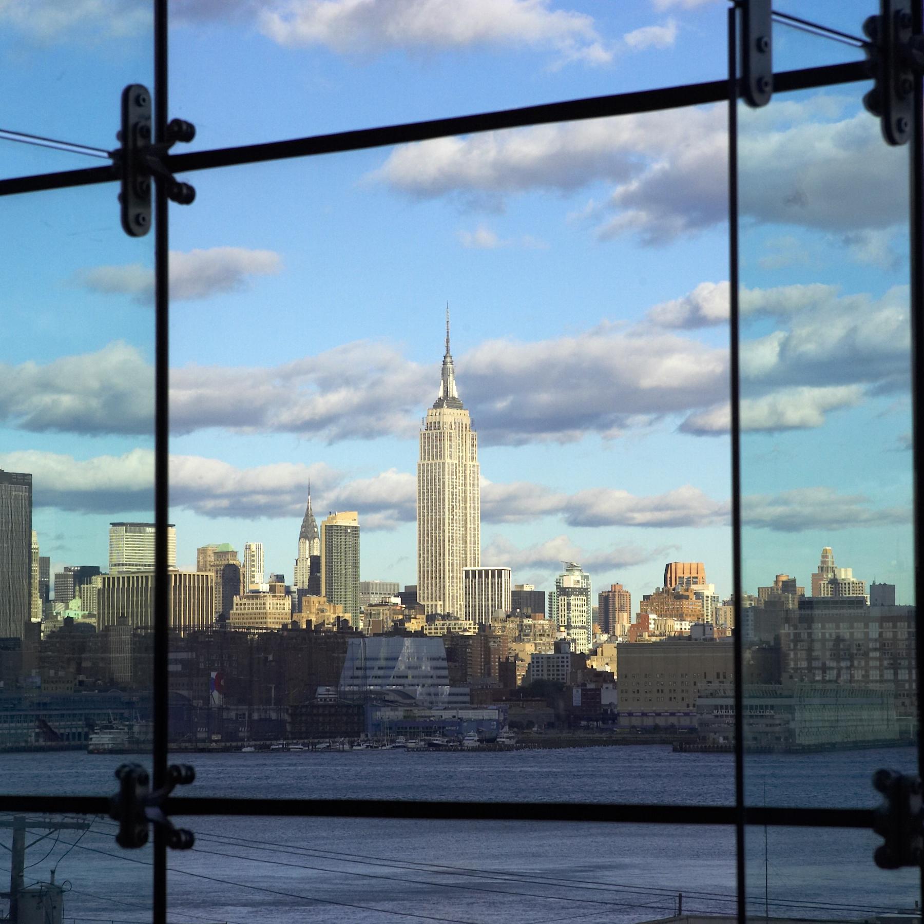 The Empire State Building framed through a floor-to-ceiling window on campus