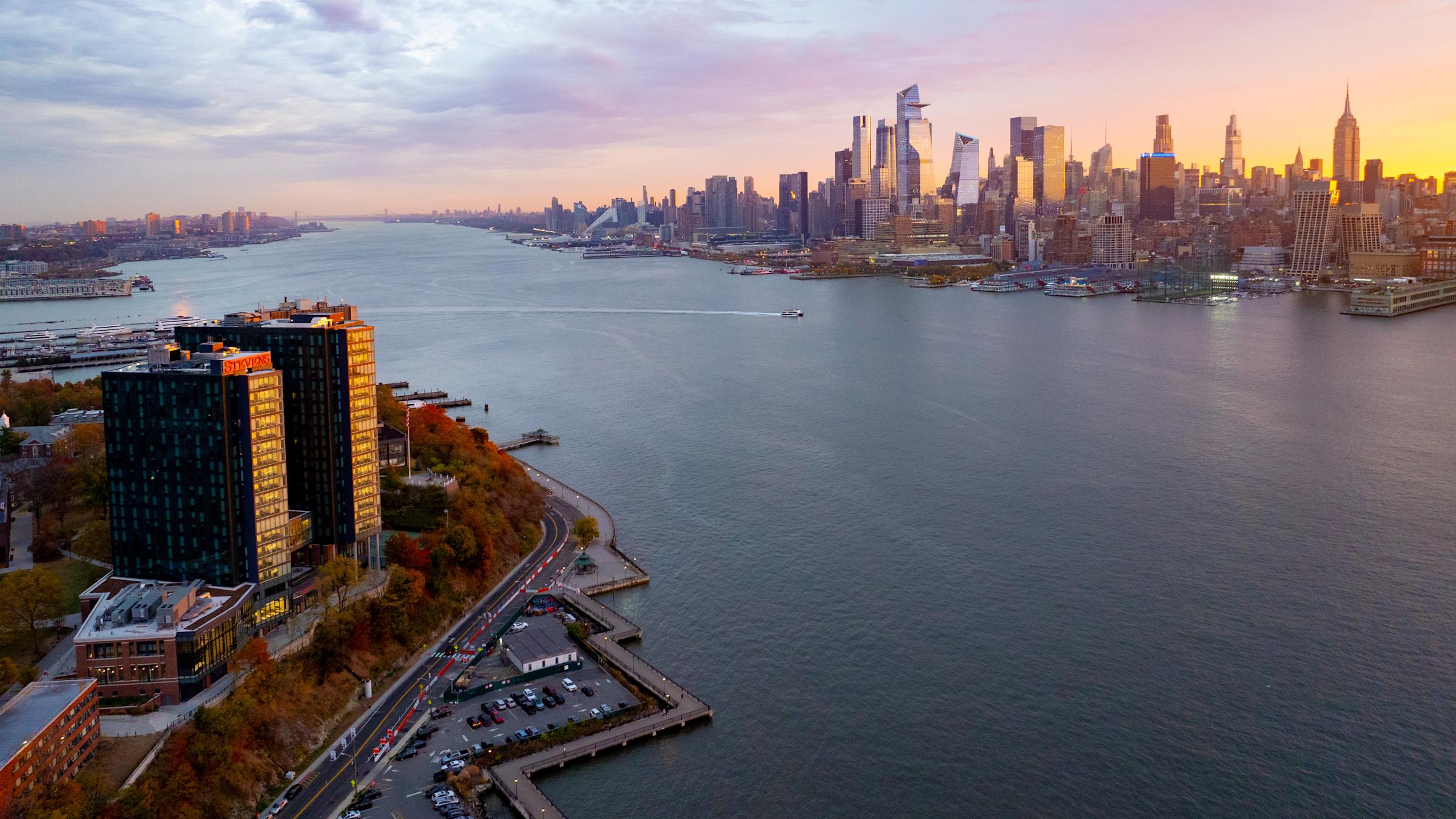 Sunrise over the Hoboken waterfront campus with the Manhattan skyline across the Hudson River