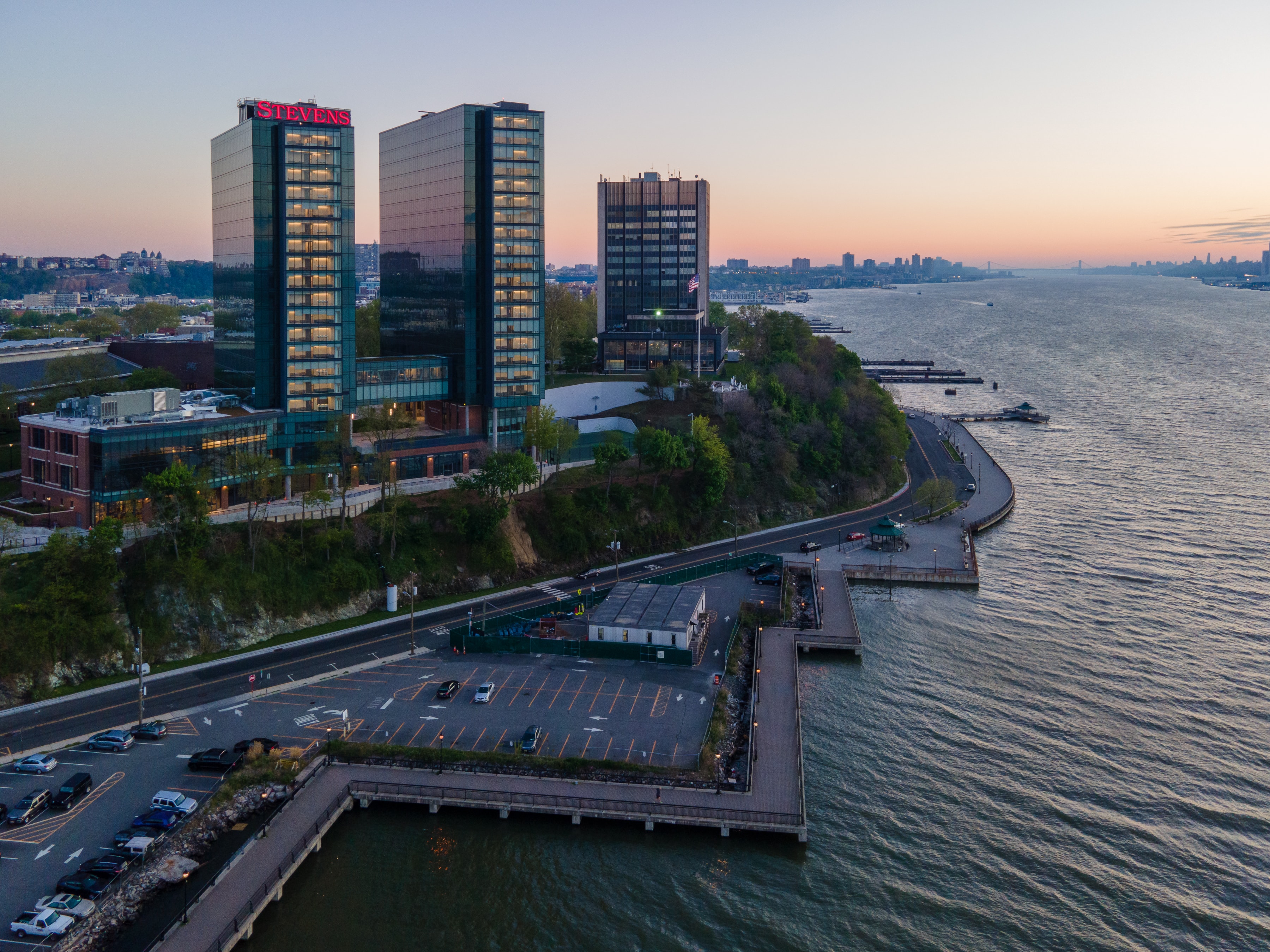 Aerial of the campus towers at dusk above the Hoboken waterfront
